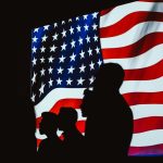 silhouette of four person with flag of united states background