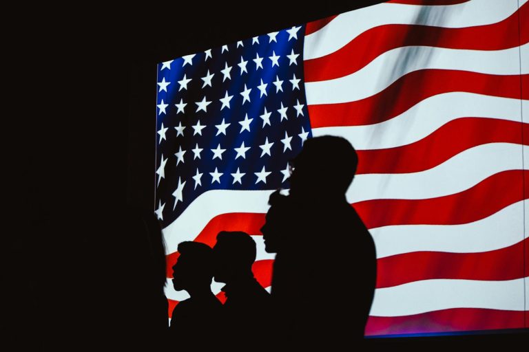 silhouette of four person with flag of united states background