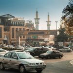 busy tehran street with mosque and traffic