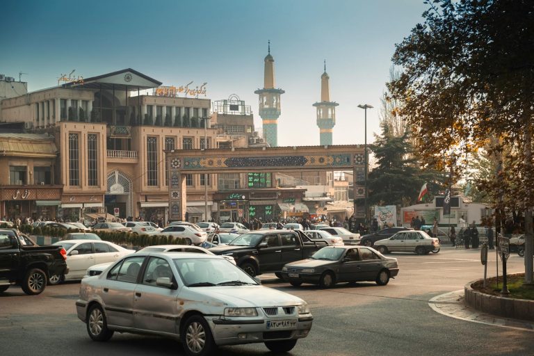 busy tehran street with mosque and traffic